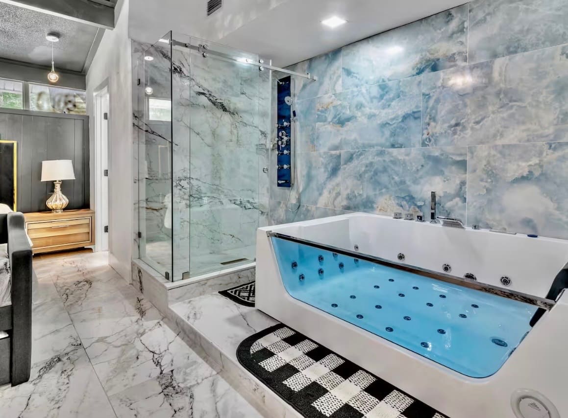 Finished bathroom remodel with jetted tub and blue onyx tile wall — REV Home Solutions