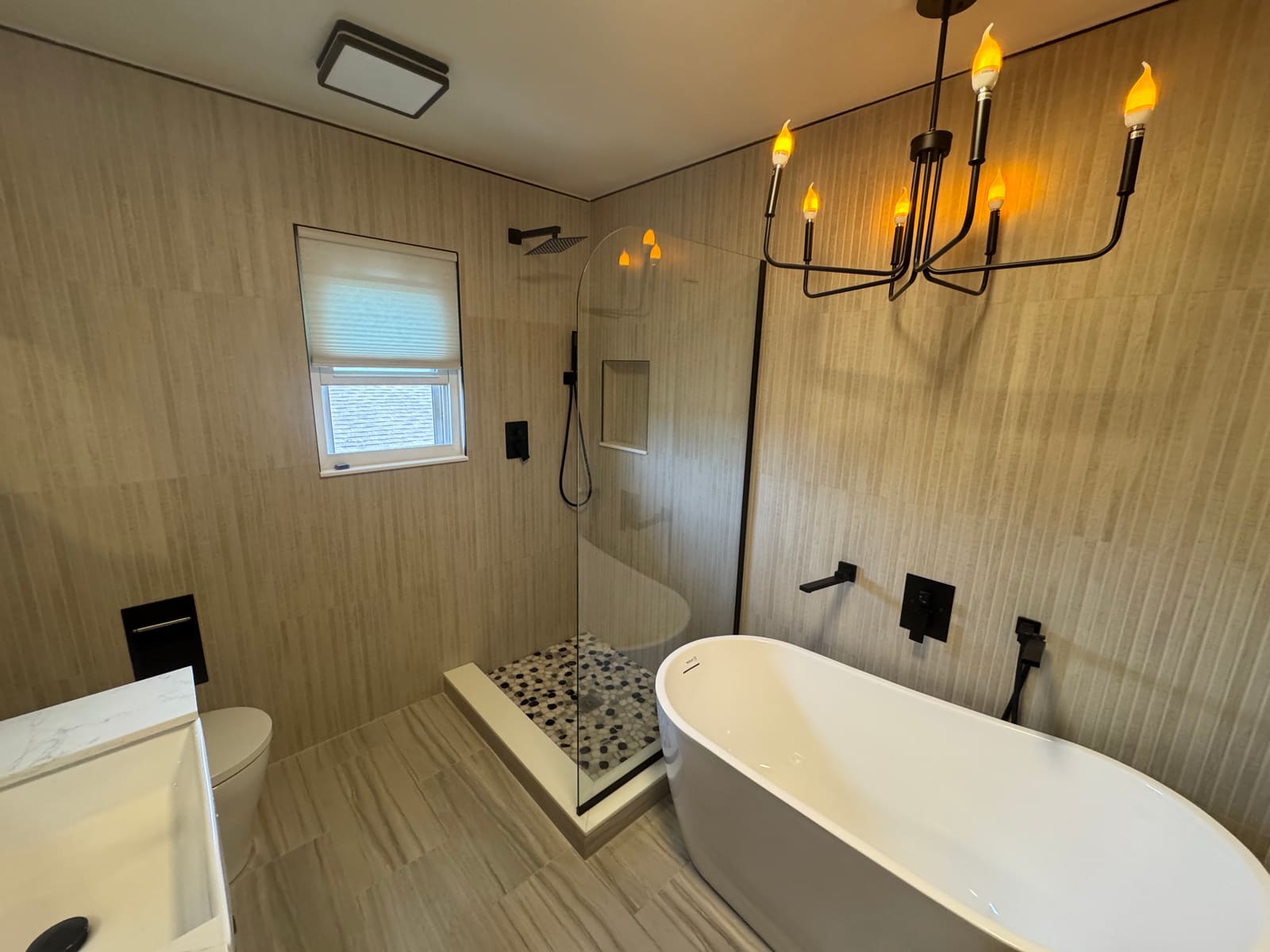 Finished bathroom remodel with walk-in shower and freestanding soaking tub — REV Home Solutions