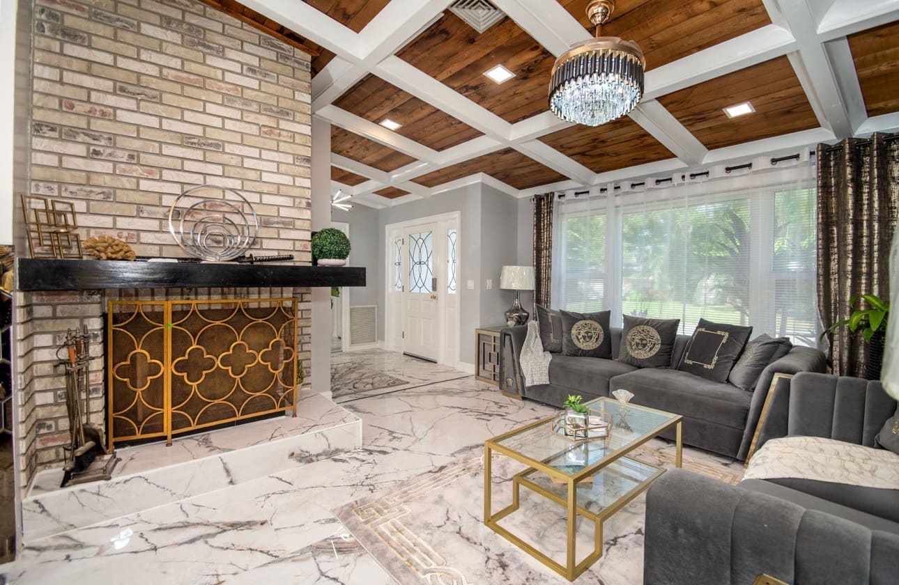 Finished living room remodel with brick fireplace and marble flooring — REV Home Solutions