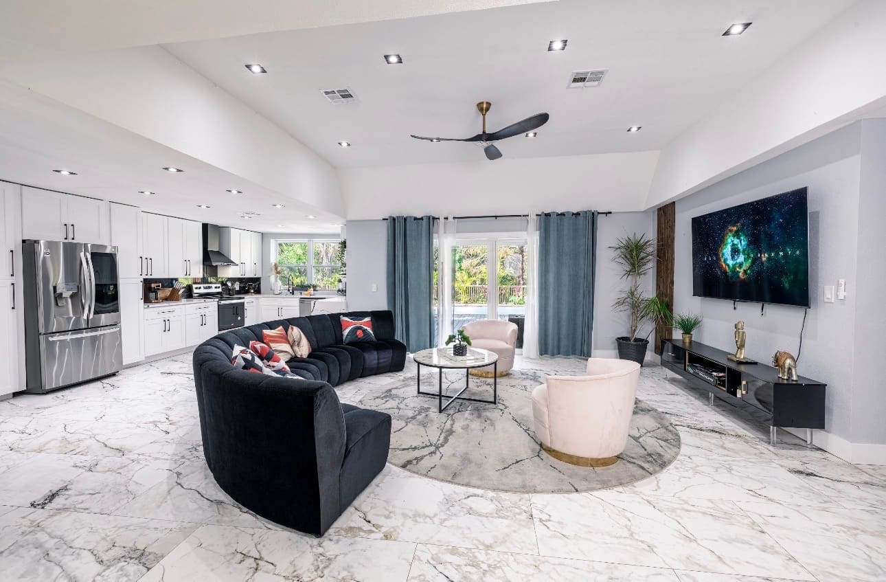 Finished open-concept living room remodel with marble flooring — REV Home Solutions