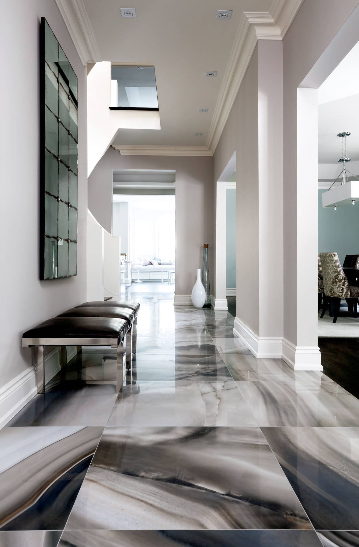 Finished marble-look tile flooring installation in a hallway — REV Home Solutions