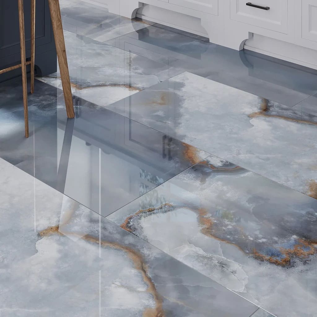 Close-up detail of finished marble-look tile flooring — REV Home Solutions