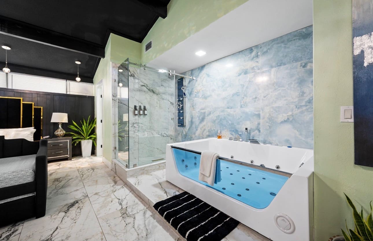 Custom shower and jetted tub with blue marble tile — REV Home Solutions