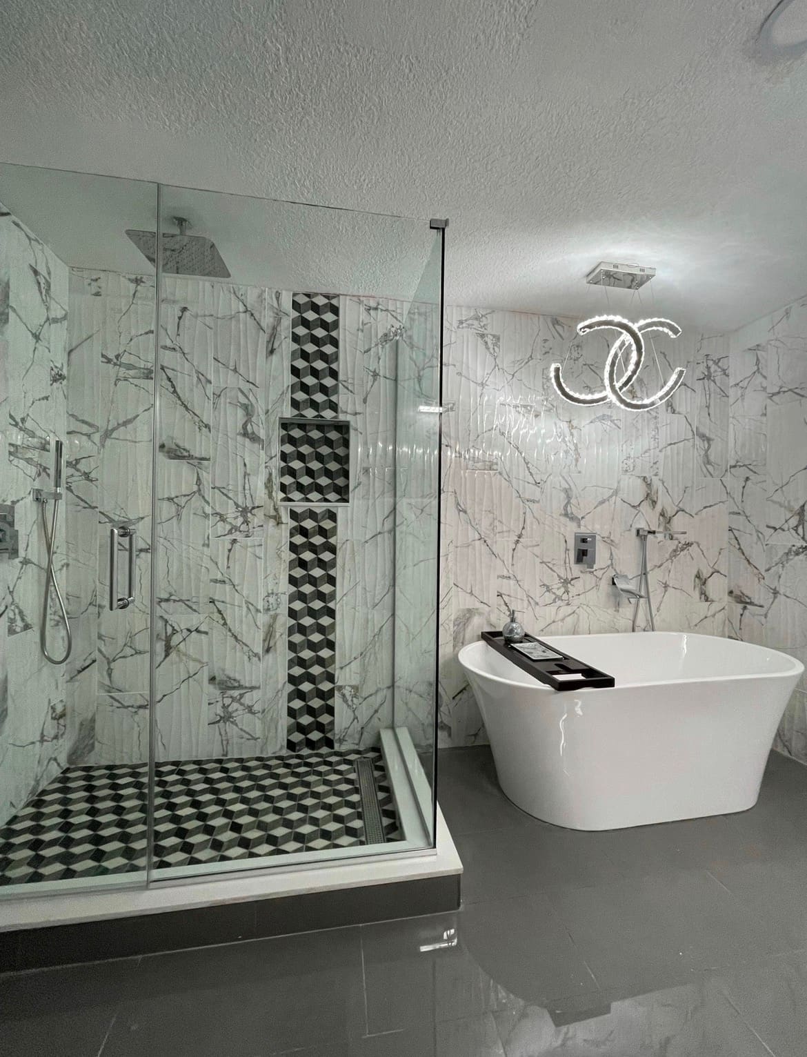 Finished walk-in shower with geometric marble mosaic tile — REV Home Solutions